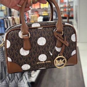 Elegant Black Leather Satchel with Gold Accents and Adjustable Strap